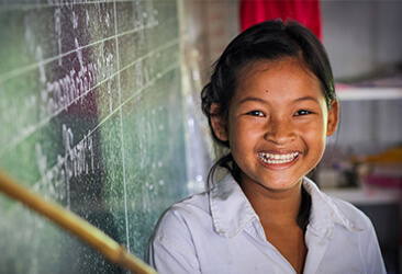 a girl smiling in a classroom